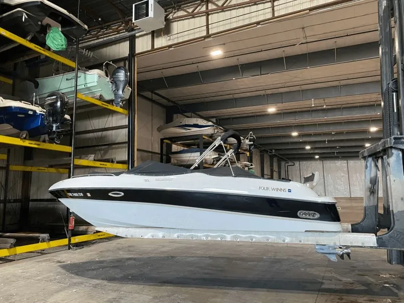 The Image of 1998 Four Winns 240 Horizon boat in storage facility. - 0