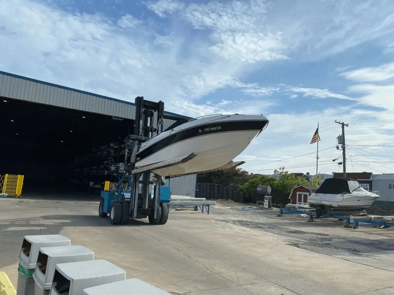 Slide: The Image of Forklift lifting 1998 Four Winns 240 Horizon boat. - 13