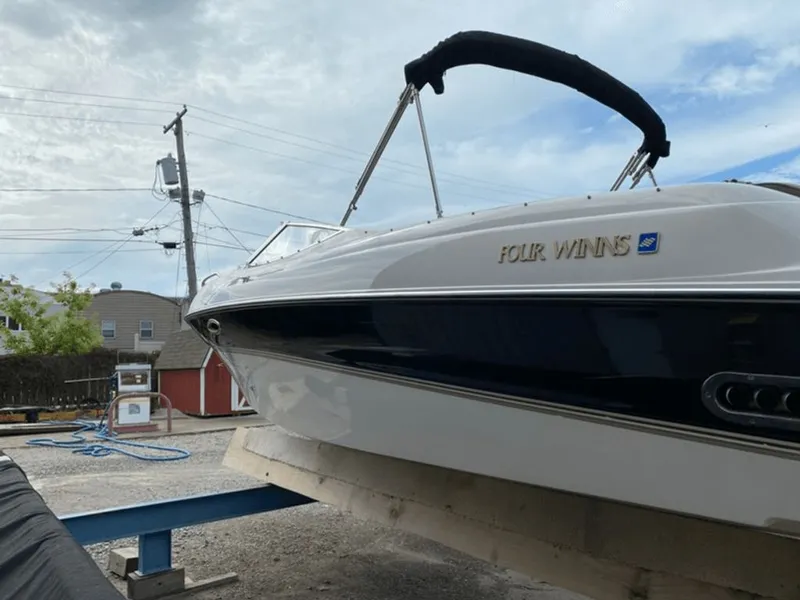 Slide: The Image of 1998 Four Winns 240 Horizon boat on a dock. - 14