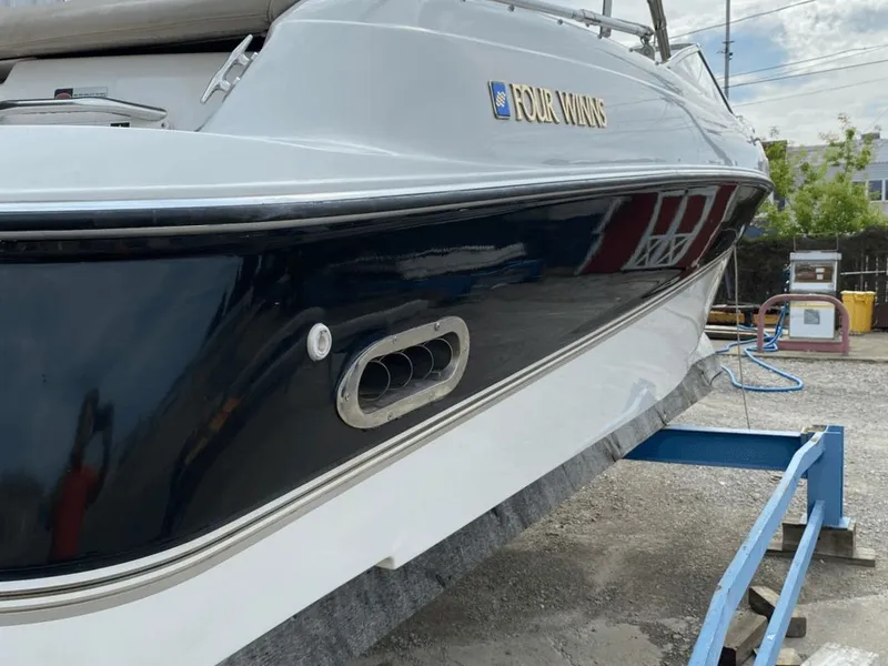 Slide: The Image of 1998 Four Winns 240 Horizon boat on a blue stand. - 15