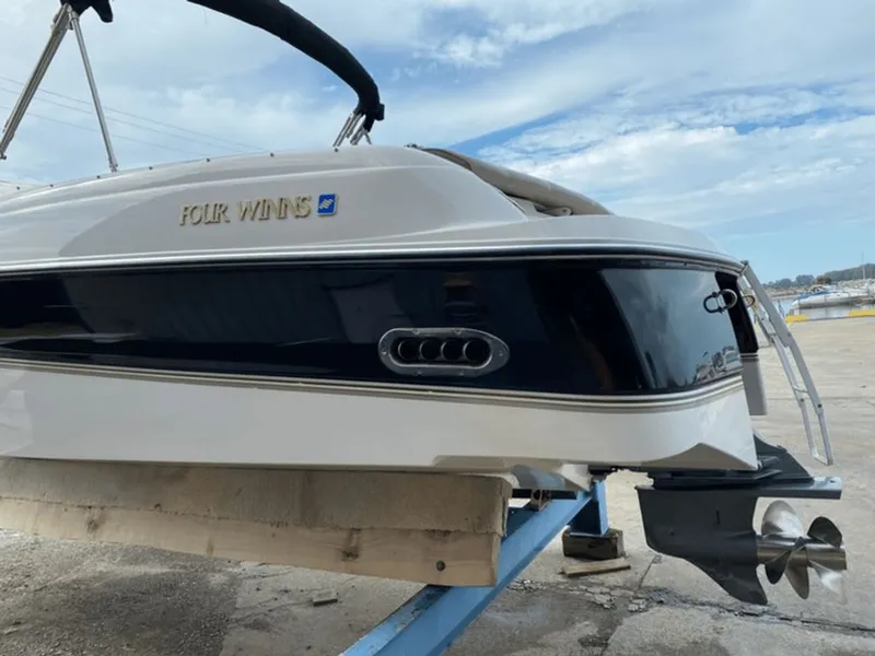 Slide: The Image of 1998 Four Winns 240 Horizon boat at dock. - 17