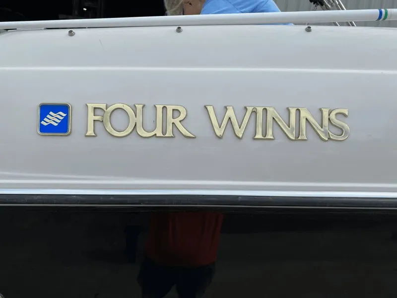 Slide: The Image of 1998 Four Winns 240 Horizon boat logo on white background. - 20