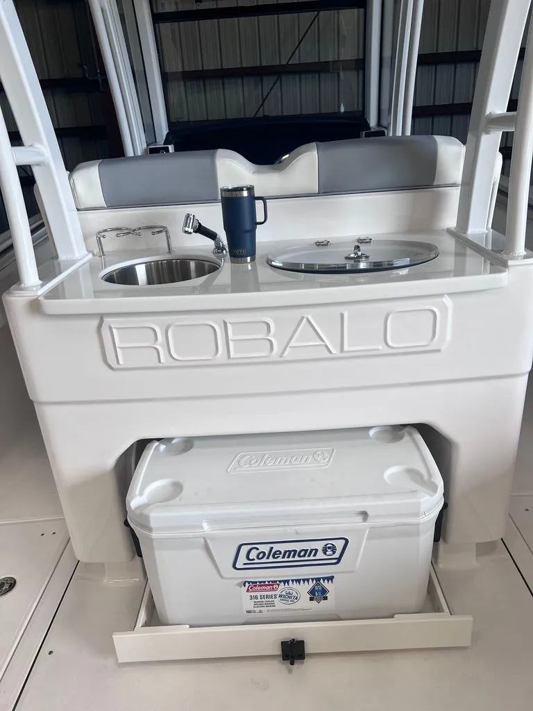 Slide: The Image of Robalo R302 Center Console 2023 with sink and Coleman cooler. - 10