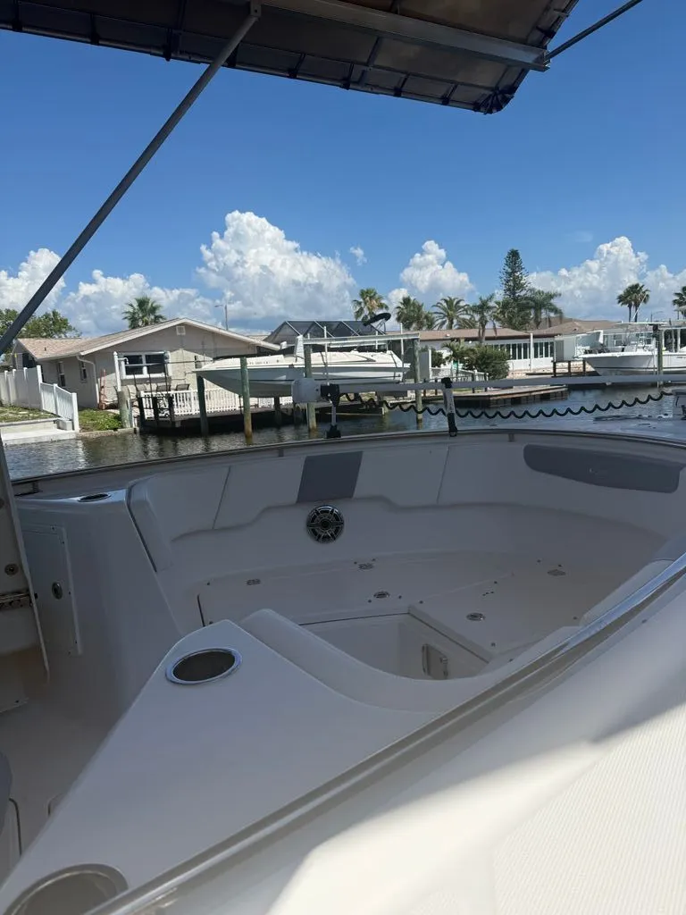 Slide: The Image of Interior view of a 2023 Robalo R302 Center Console boat at dock. - 12