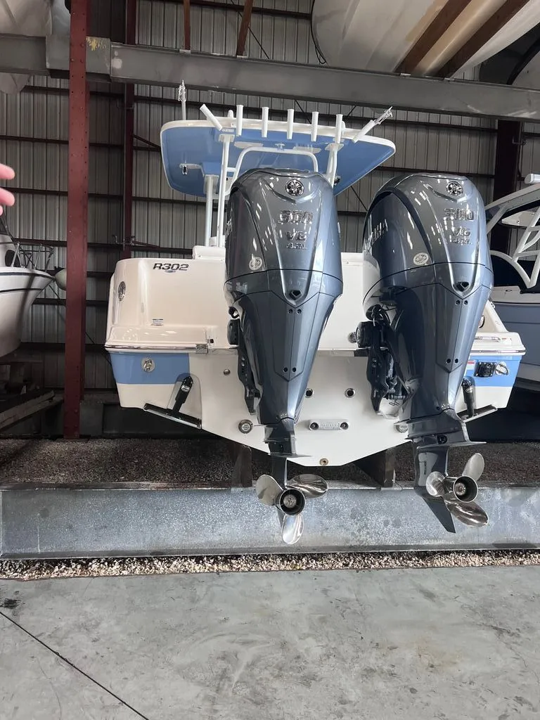 Slide: The Image of 2023 Robalo R302 Center Console with dual outboard engines. - 14