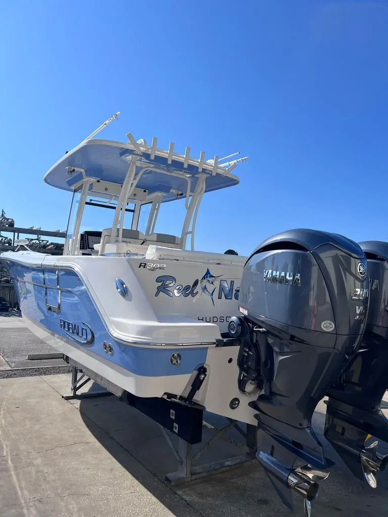 Slide: The Image of 2023 Robalo R302 Center Console boat with Yamaha engines. - 2