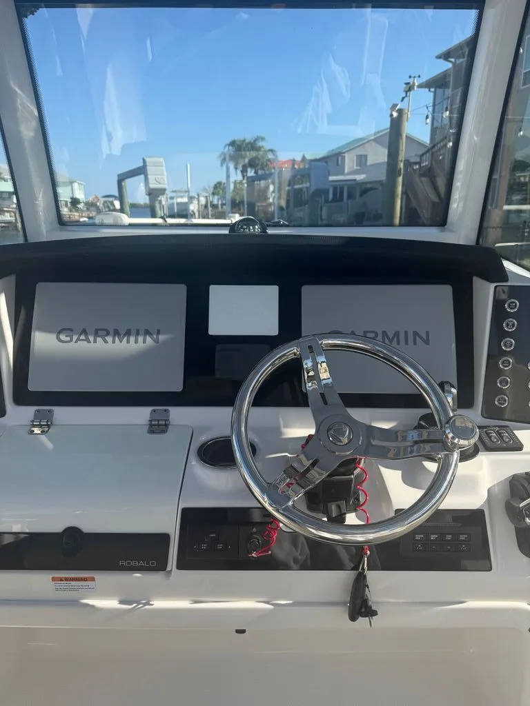 Slide: The Image of Robalo R302 Center Console 2023 helm with Garmin displays. - 5