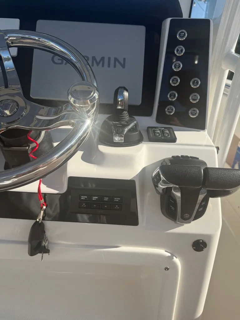 Slide: The Image of Robalo R302 Center Console 2023 helm with Garmin display. - 6