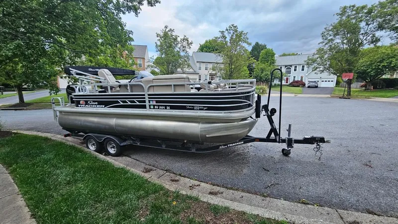 The Image of 2020 Tracker Fishin' Barge on trailer parked in residential area. - 0
