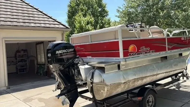 Slide: The Image of 2014 Sun Tracker Bass Buggy pontoon boat with Mercury engine in driveway. - 12