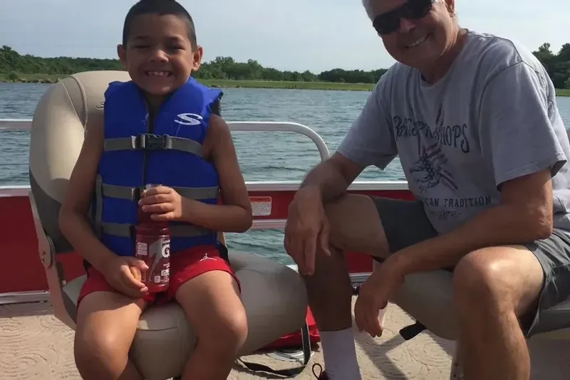 Slide: The Image of Boy and man on a 2014 Sun Tracker Bass Buggy boat. - 14