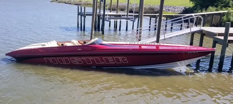 Slide: The Image of Red 2016 Hustler Slingshot boat docked. - 1