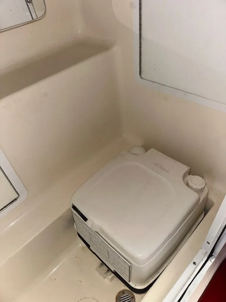 Slide: The Image of Interior of a 2016 Hustler Slingshot with portable toilet. - 10