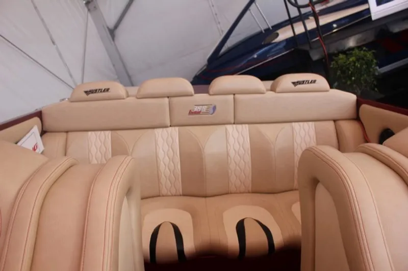 Slide: The Image of Interior of a 2016 Hustler Slingshot with beige leather seats. - 13