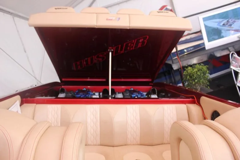 Slide: The Image of 2016 Hustler Slingshot interior with open engine compartment lid. - 14