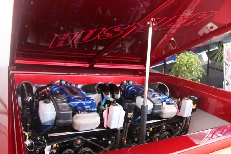 Slide: The Image of 2016 Hustler Slingshot engine compartment with open hood. - 16