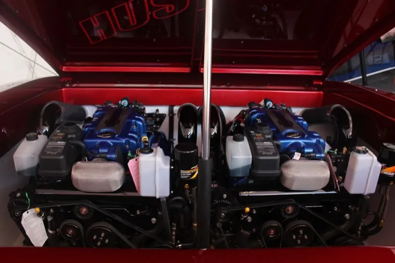 Slide: The Image of 2016 Hustler Slingshot engine bay with dual blue engines. - 18