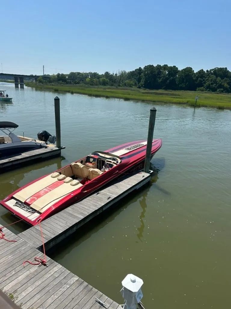 Slide: The Image of 2016 Hustler Slingshot boat docked on a sunny day. - 26