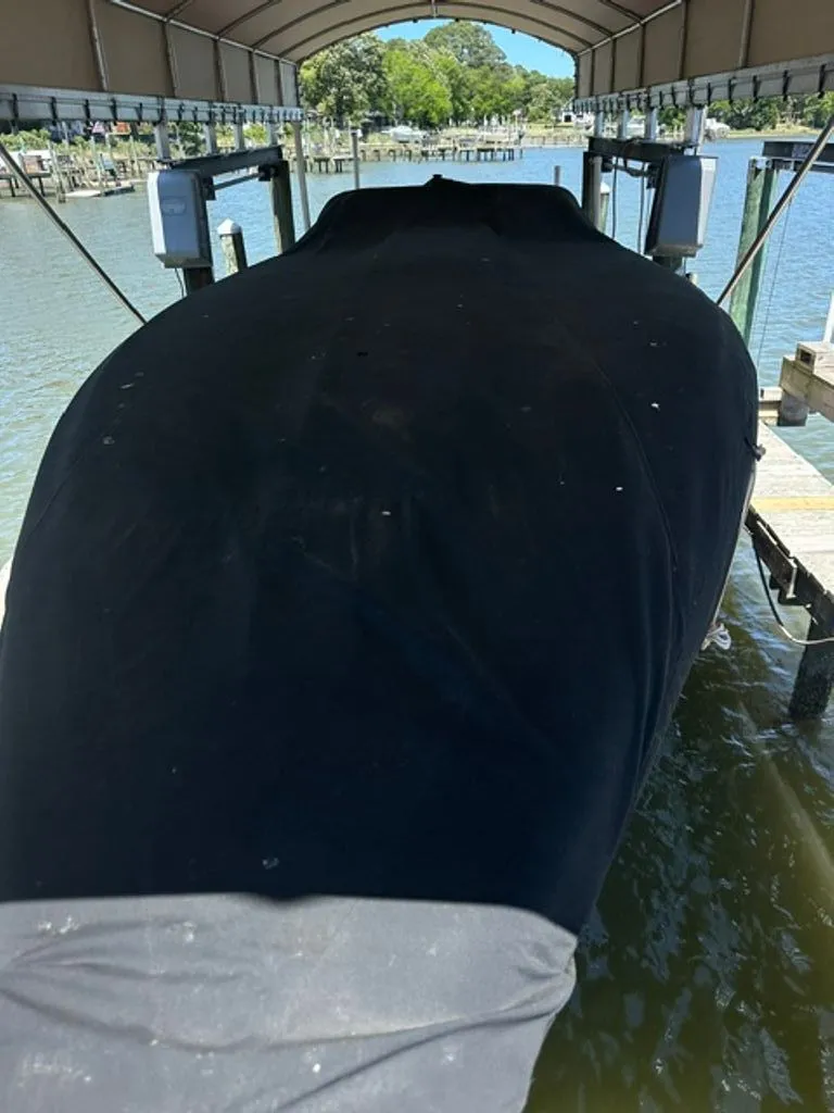 Slide: The Image of 2016 Hustler Slingshot boat covered on a boat lift. - 28