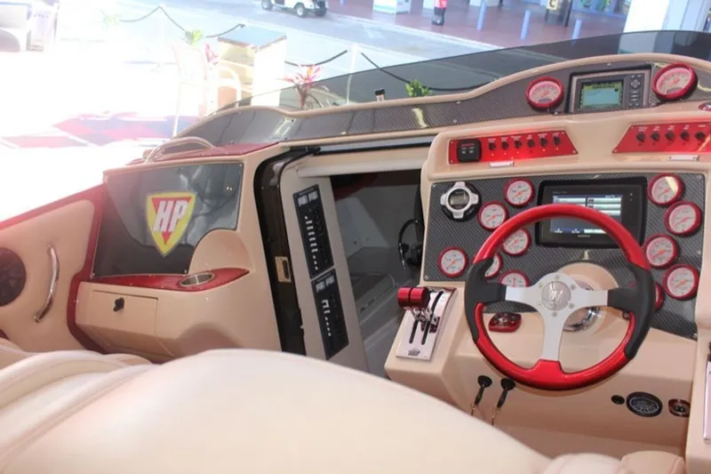 Slide: The Image of Interior of a 2016 Hustler Slingshot with red steering wheel and dashboard. - 4