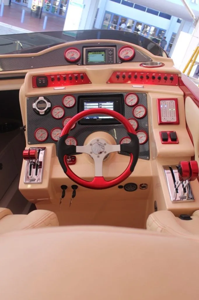 Slide: The Image of 2016 Hustler Slingshot cockpit with red accents and instruments. - 5