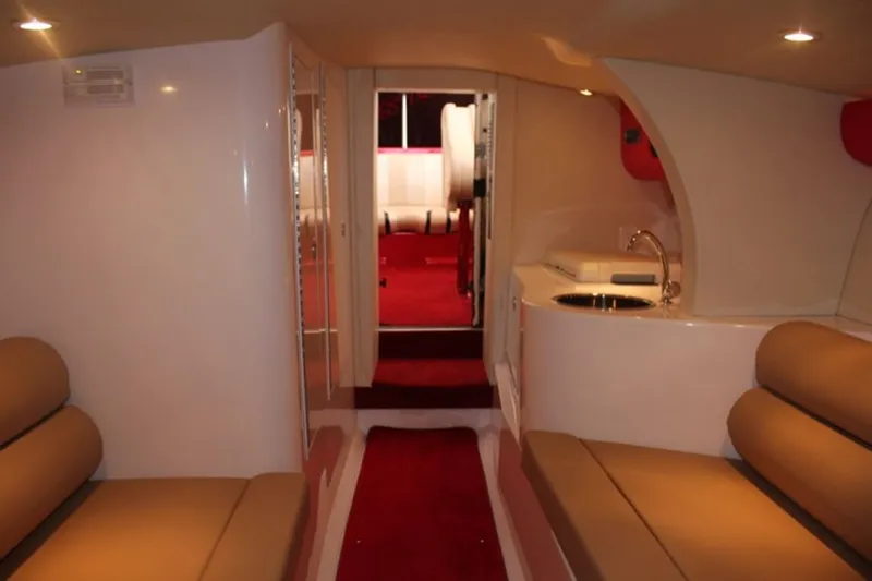 Slide: The Image of Interior of 2016 Hustler Slingshot with red carpets and beige seating. - 8