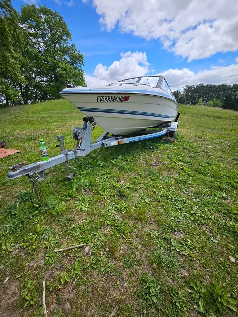 Slide: The Image of 1991 Sunbird Corsair boat on trailer in grassy field. - 1