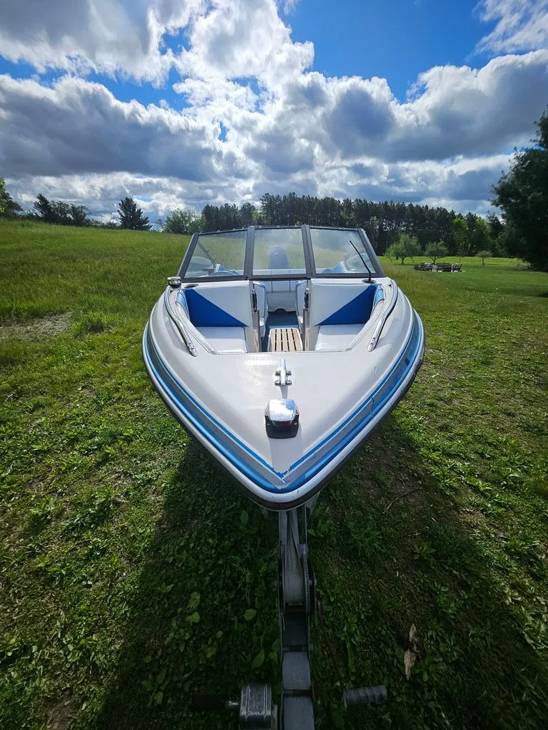 Slide: The Image of 1991 Sunbird Corsair boat on green field under blue sky. - 4