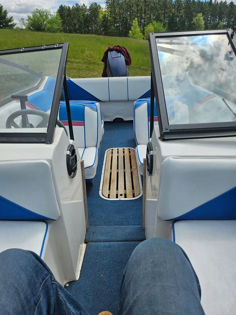 Slide: The Image of Interior of a 1991 Sunbird Corsair boat with blue and white seating. - 5