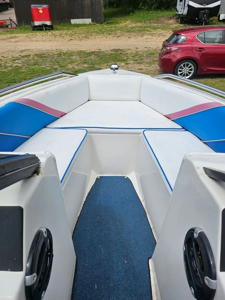 Slide: The Image of Interior of a 1991 Sunbird Corsair boat with blue and white seating. - 9