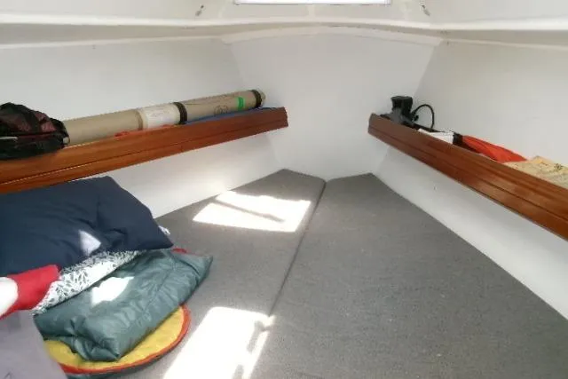 Slide: The Image of Cozy cabin interior of 2000 Bavaria Yachts sloop with cushions and wooden shelves. - 4