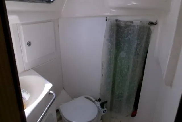 Slide: The Image of Compact bathroom in a 2000 Bavaria Yachts sloop, featuring a toilet and sink. - 7