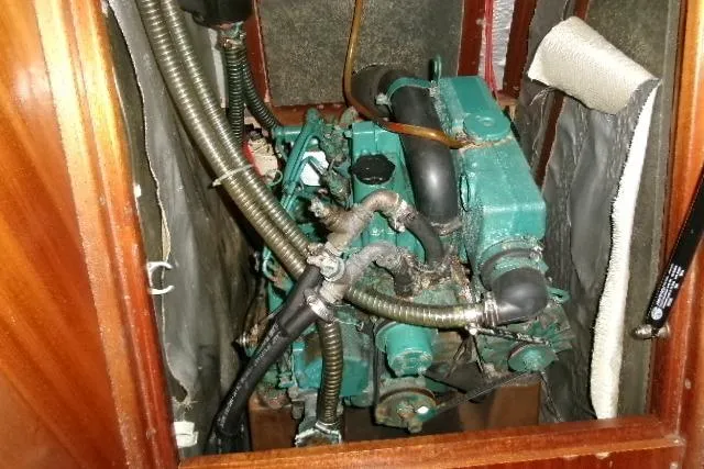 Slide: The Image of Engine compartment of a 2000 Bavaria Yachts sloop, showcasing mechanical components and hoses. - 8