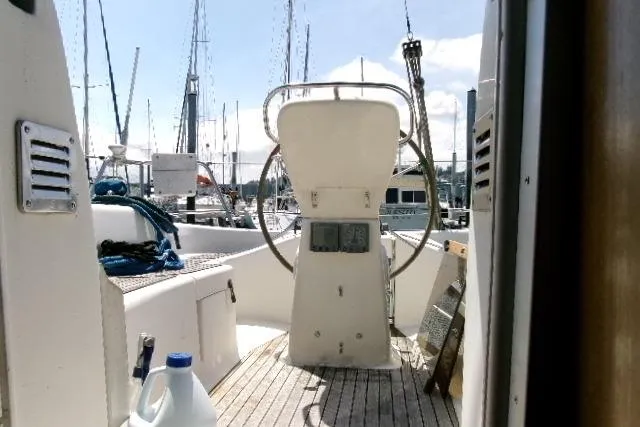 Slide: The Image of Cockpit view of a 2000 Bavaria Yachts sloop docked at a marina. - 9
