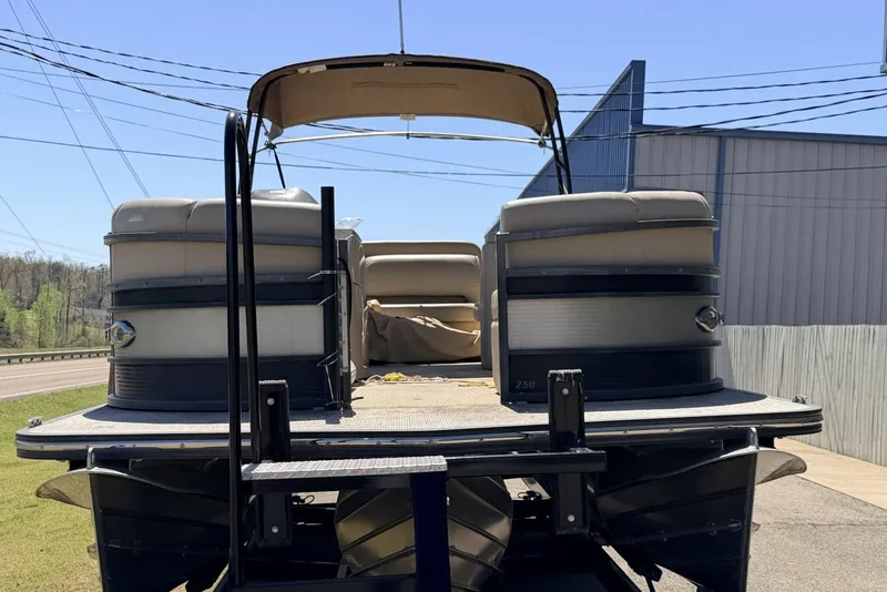 Slide: The Image of 2017 Manitou 25 SES BENCH pontoon boat with canopy, docked outdoors. - 8