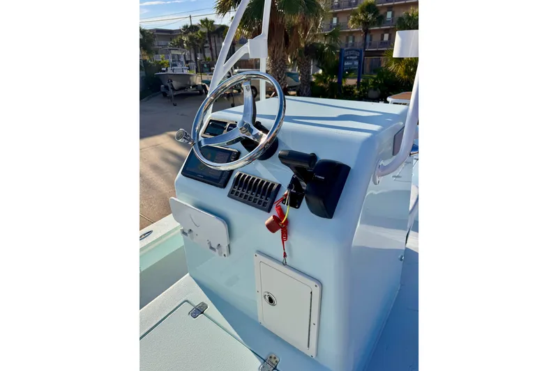 Slide: The Image of Steering console of 2023 Waterman Wildwater 23 boat, featuring modern controls and sleek design. - 10