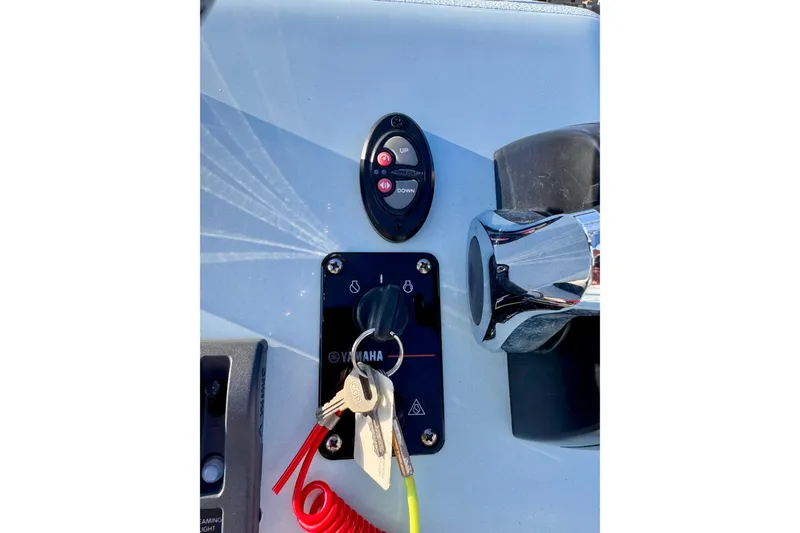 Slide: The Image of Control panel of 2023 Waterman Wildwater 23 boat with Yamaha ignition and keys. - 14