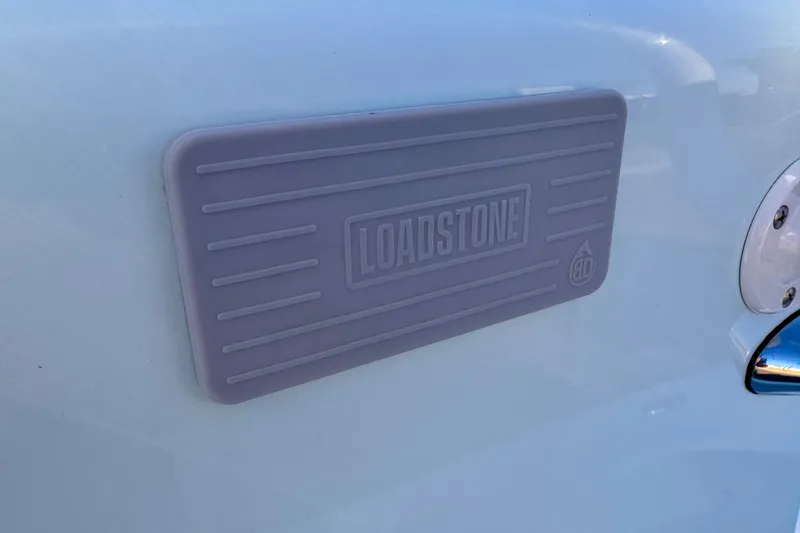 Slide: The Image of Loadstone logo on Waterman Wildwater 23 boat, 2023 model, featuring sleek design. - 20