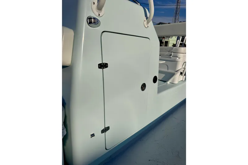 Slide: The Image of 2023 Waterman Wildwater 23 boat side view with storage compartment and seating. - 21