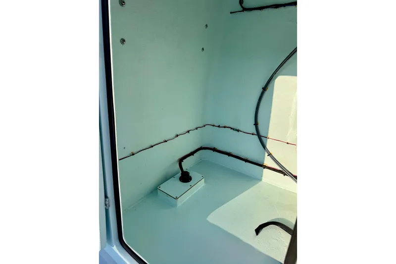 Slide: The Image of Interior view of 2023 Waterman Wildwater 23 boat compartment with wiring and fittings. - 23
