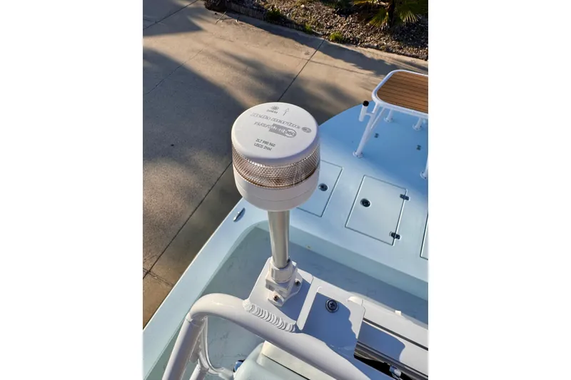 Slide: The Image of 2023 Waterman Wildwater 23 boat with a mounted navigation light on deck. - 24