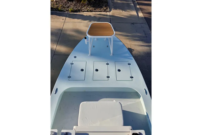 Slide: The Image of 2023 Waterman Wildwater 23 boat deck with storage compartments and elevated platform. - 26