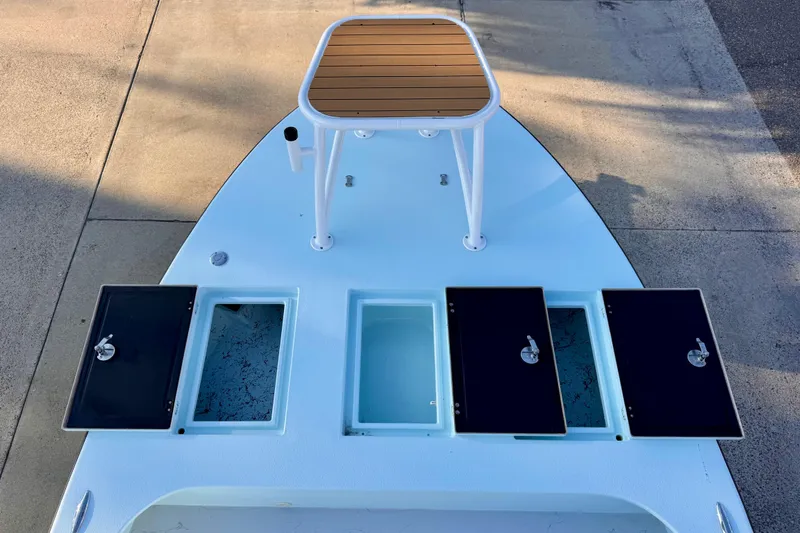 Slide: The Image of 2023 Waterman Wildwater 23 boat deck with storage compartments and a raised platform. - 27