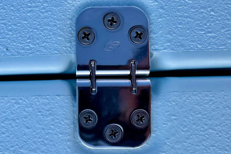 Slide: The Image of Close-up of a metal hinge on a textured blue surface, Waterman Wildwater 23 model. - 28