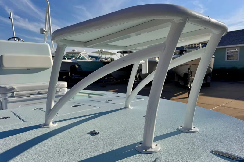 Slide: The Image of 2023 Waterman Wildwater 23 boat detail, showcasing sturdy white metal framework under clear blue sky. - 30