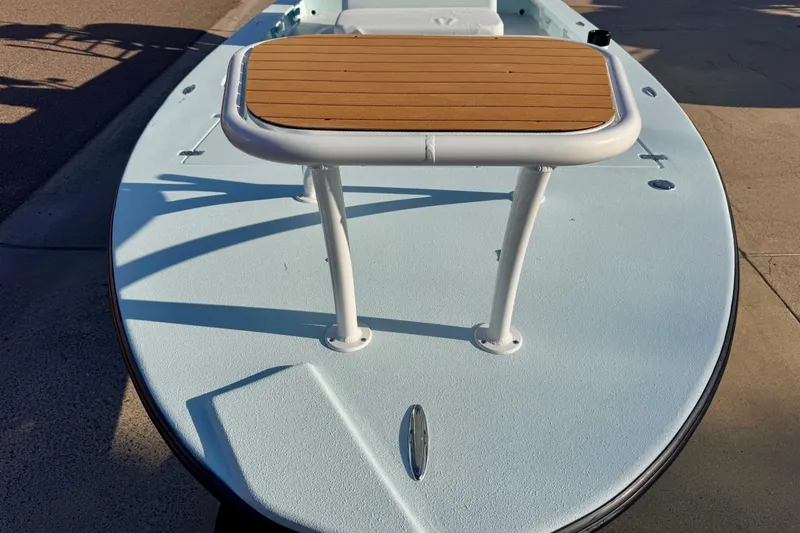 Slide: The Image of Front view of a 2023 Waterman Wildwater 23 boat with a wooden deck platform. - 31