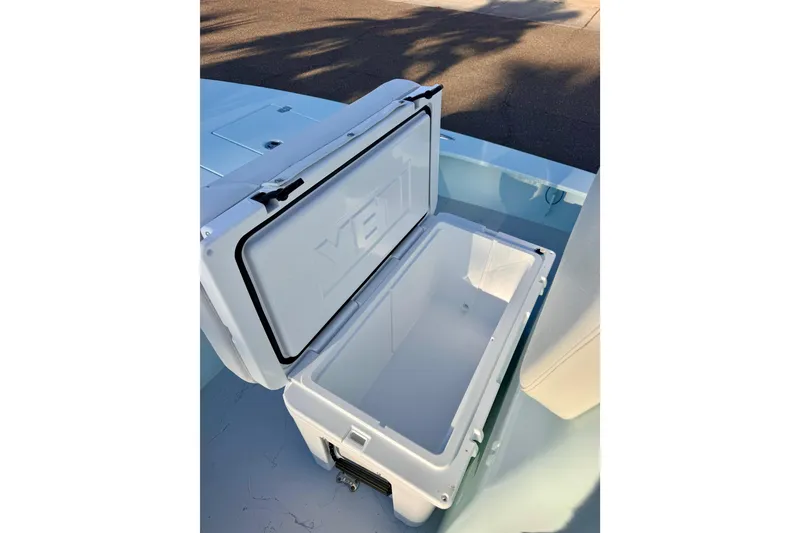 Slide: The Image of Open cooler on Waterman Wildwater 23 boat, 2023 model, with sunlight casting shadows. - 33
