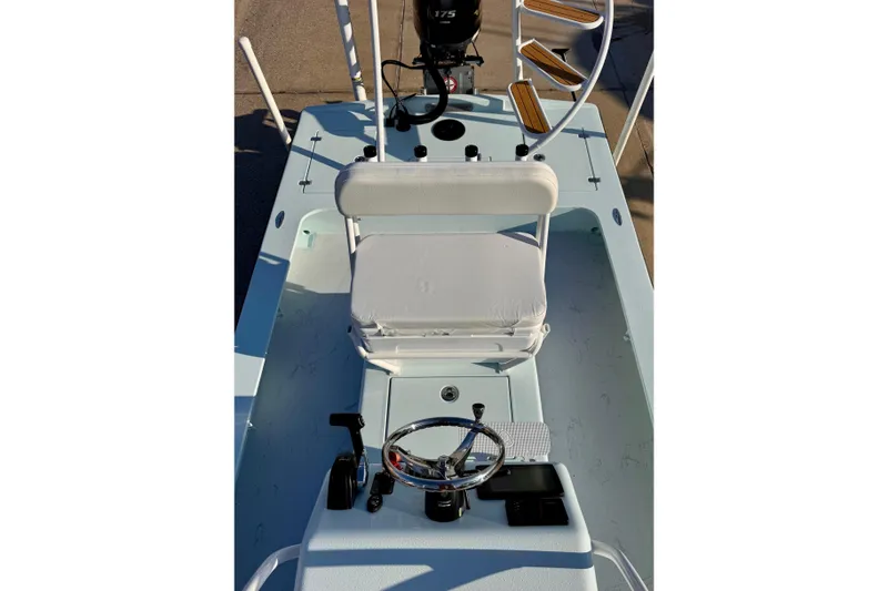 Slide: The Image of 2023 Waterman Wildwater 23 boat interior with steering wheel and seating. - 34
