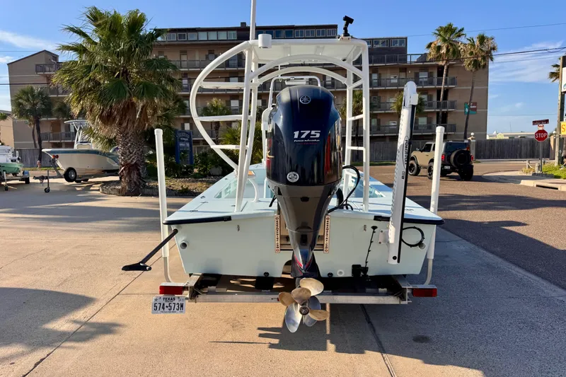 Slide: The Image of Waterman Wildwater 23 boat, 2023 model, with 175 horsepower engine, parked on a trailer. - 4