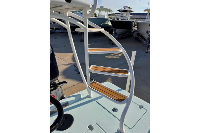 Slide: The Image of Staircase on Waterman Wildwater 23 boat, 2023 model, with wooden steps and white frame. - 42